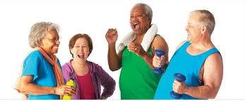 Four adult seniors in exercise clothing holding hand weights, water bottles, etc.