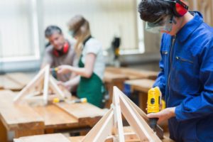 Click on this image of youth working in a shop class to learn about Hamilton County 4-H programs related to vocational goals, including the robotics club.