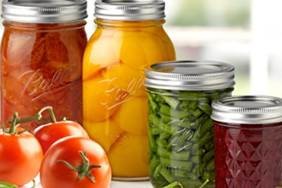 Canning jars with various fruits/vegetables.
