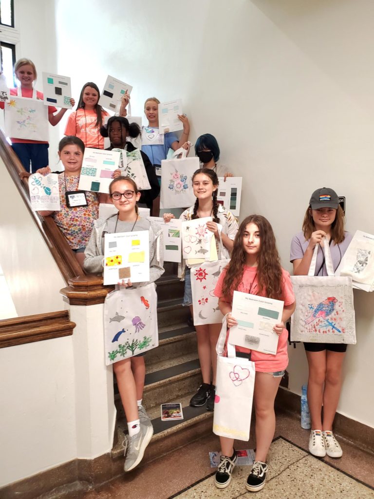 A group of youth showing the artwork they created as part of the 4-H Academic conference