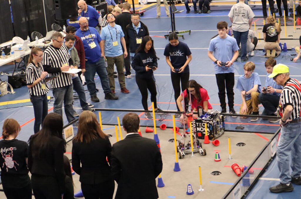 Youth and referees at a robotics competition