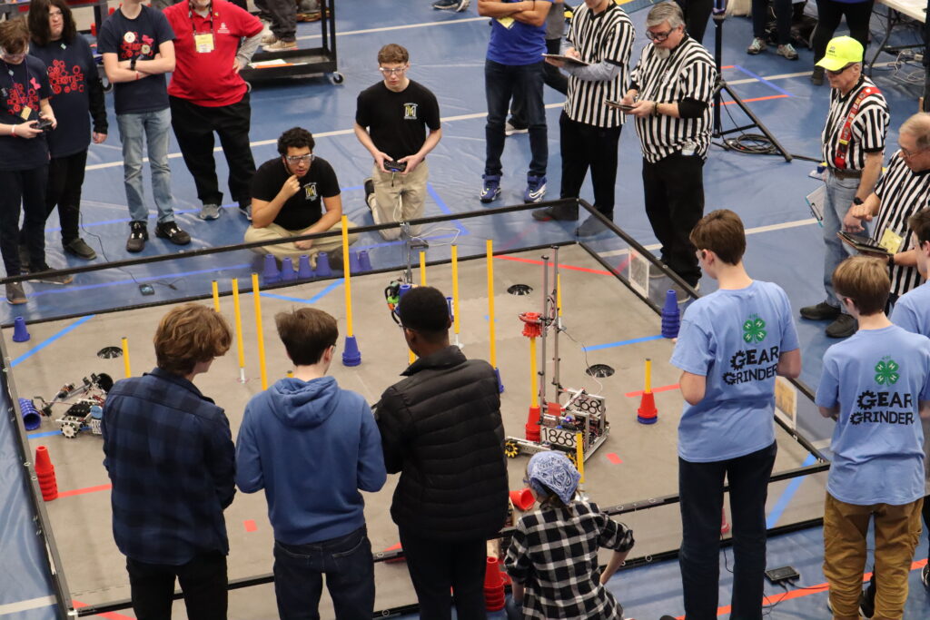 Youth and referees at a robotics competition