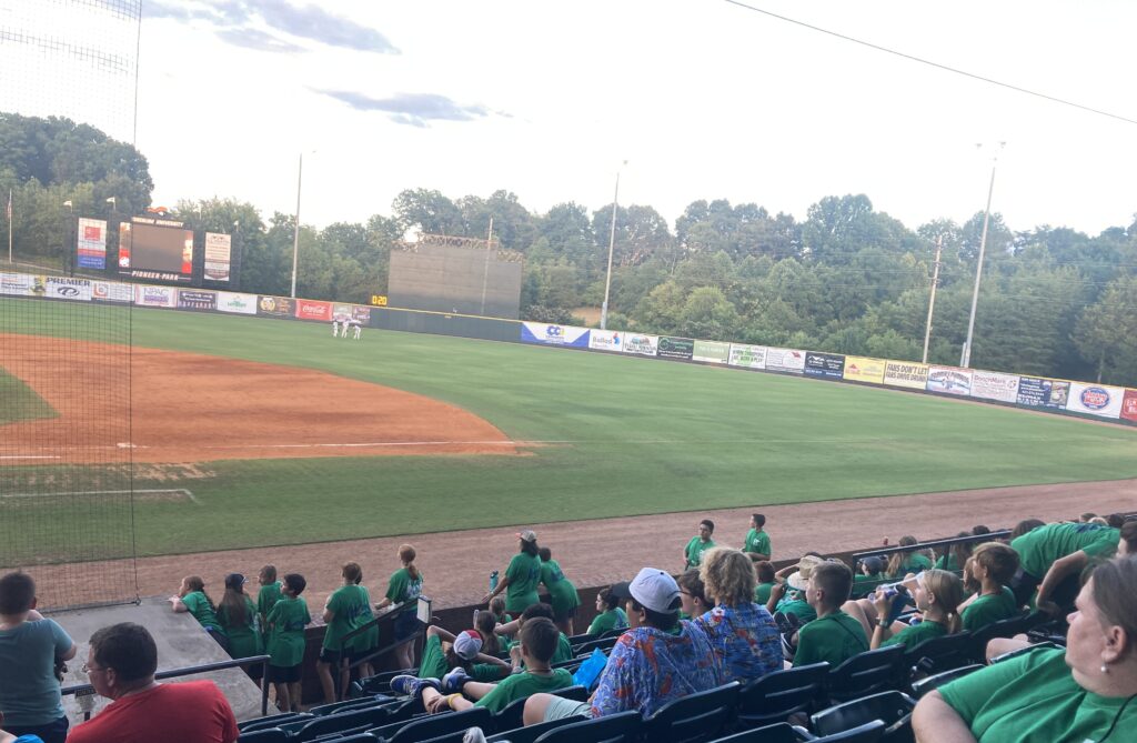 People watching a game on a baseball field