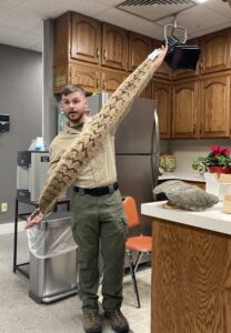 park ranger with a rattlesnake skin