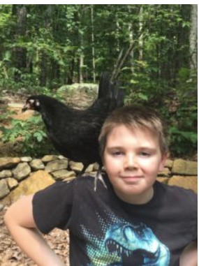 a boy with a bird on his shoulder