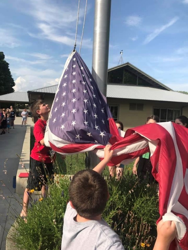 Youth in the process of raising the American flag