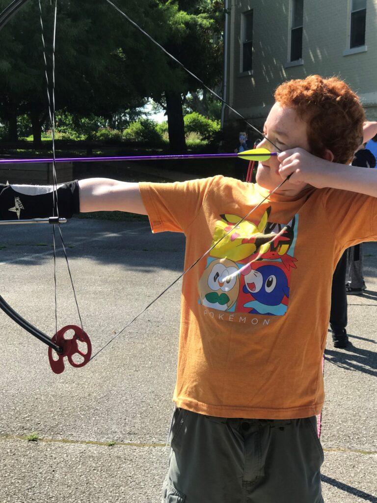 a boy shooting a bow