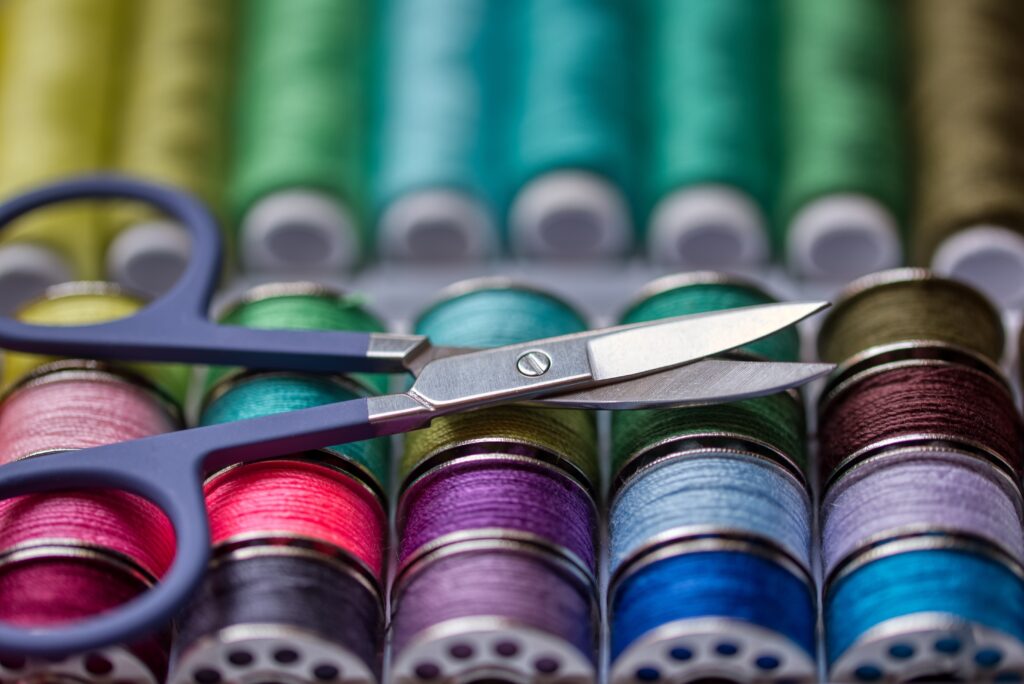 Colorful spools of thread along with a pair of scissors